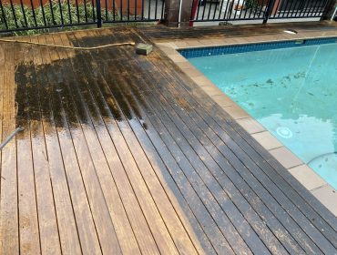 Before and after image following cleaning of wooden decking around swimming pool